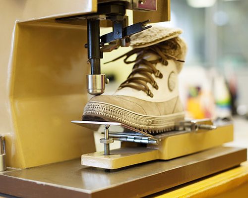 Production of brown demi-season boots, close-up